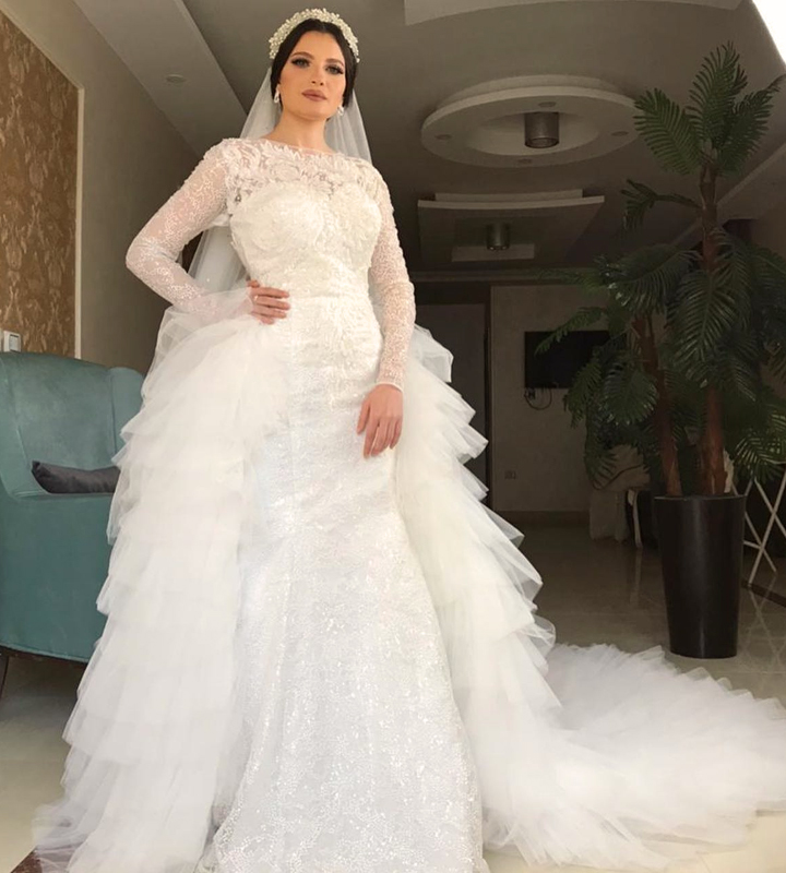فستان زفاف ابيض طويل دانتيل مطرز بالخرز والترتر اللامع باكستنشن مضاف للمحجبات وبأكمام طويله